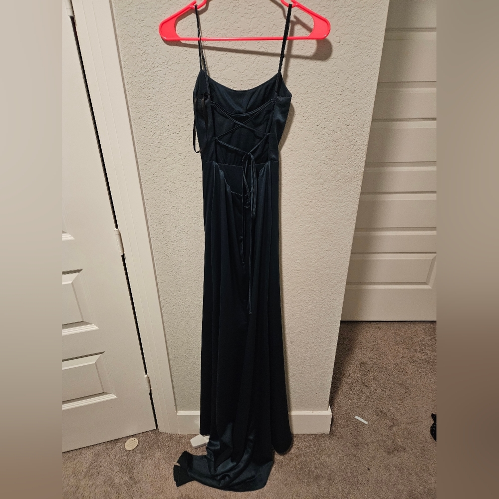 A long dark green dress with a laced back